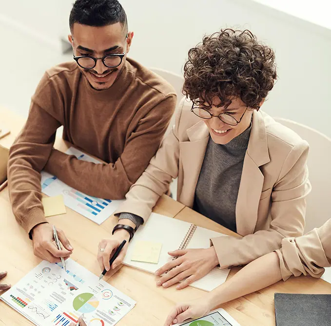 Two office worker discussing company project plan